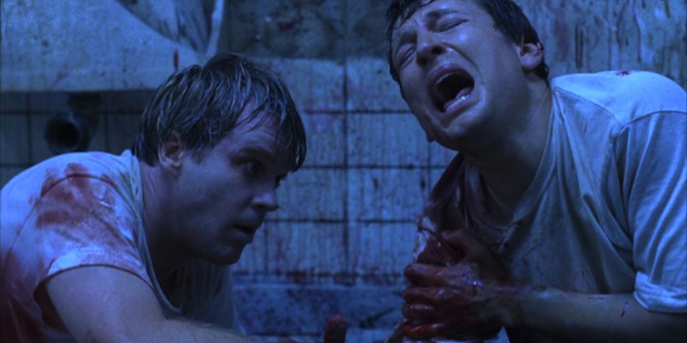 Adam, played by Leigh Whannell and Dr Gordon, played by Cary Elwes in Saw (2004)