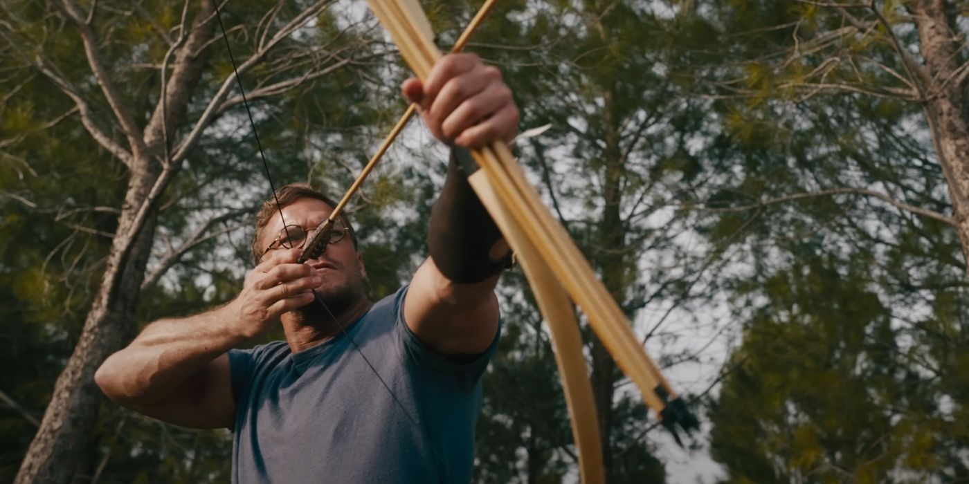 Alan Ritchson as Anders Lassen, holding a bow and arrow in The Ministry of Ungentlemanly Warfare