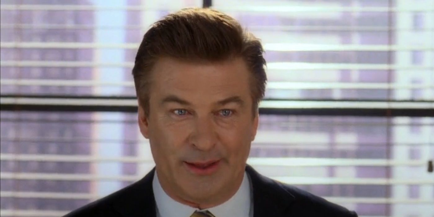 Alec Baldwin as Jack Donaghy smiling reservedly in 30 Rock