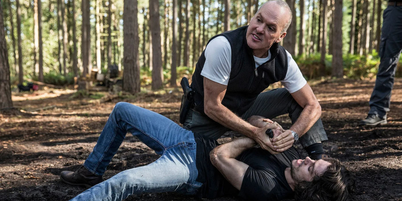 American Assassin - Dylan O'Brien as Mitch Rapp and Michael Keaton as Stan Hurley wrestling in the forest