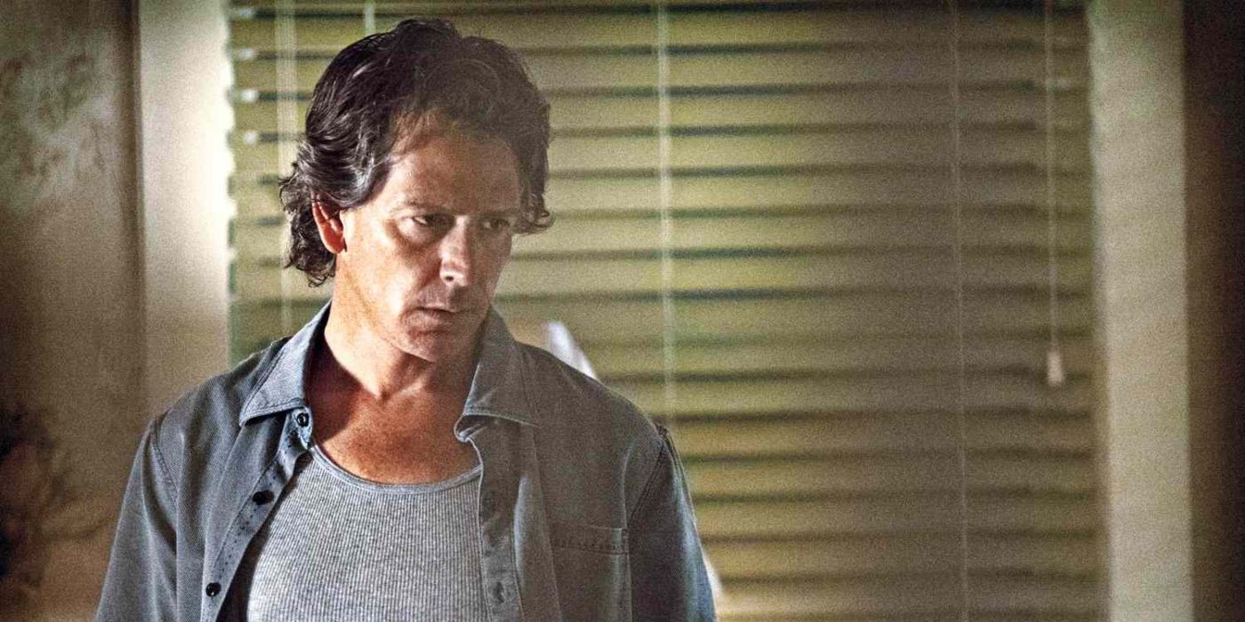 Ben Mendelsohn looks distraught standing in a room with blinds on the window in Netflix's Bloodline.