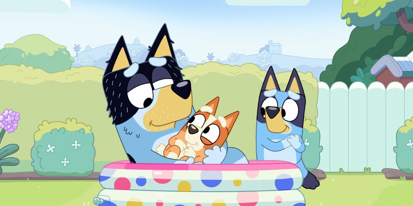 Bandit holding his baby in the paddling pool in Bluey's episode 'Dad Baby'