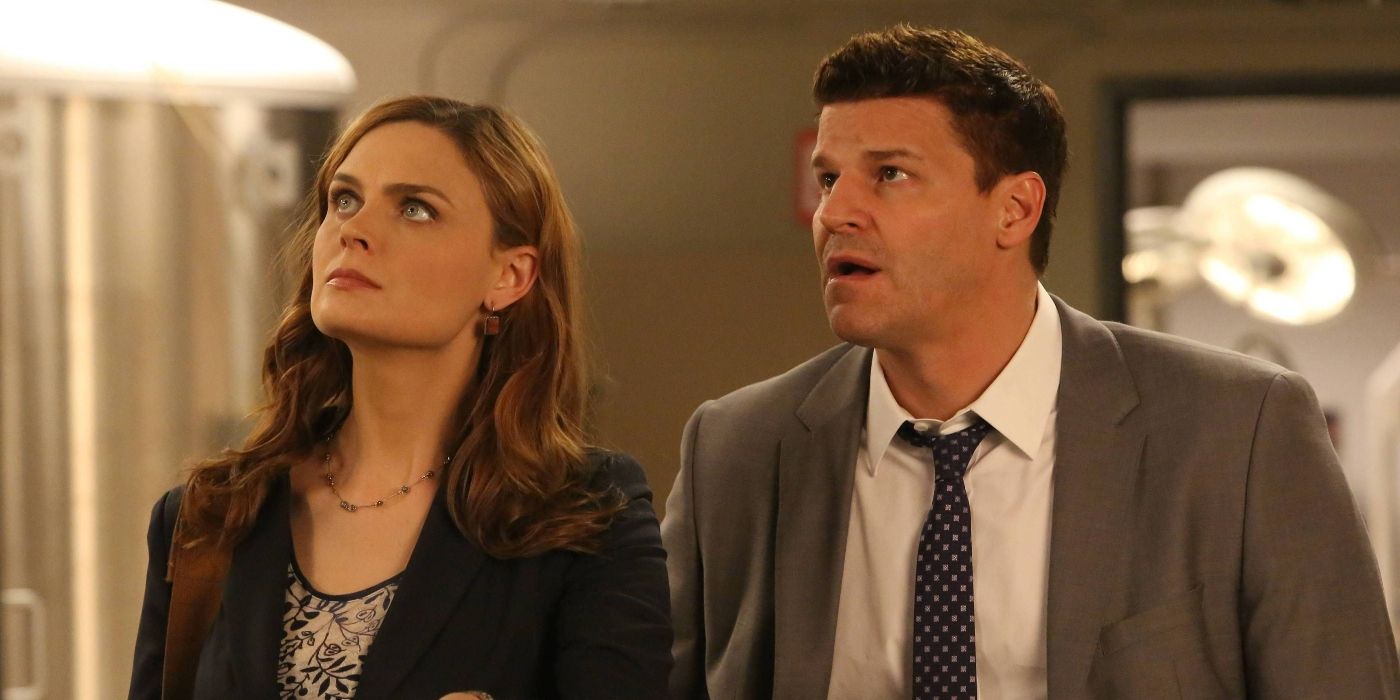 Emily Deschanel as Brennan and David Boreanaz as Booth standing together in 'Bones'