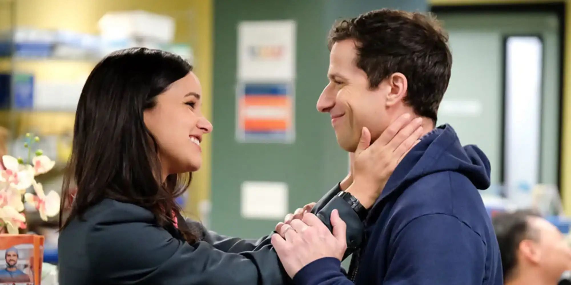 Andy Samberg as Jake and Melissa Fumero as Amy smiling at eachother in Brooklyn 99