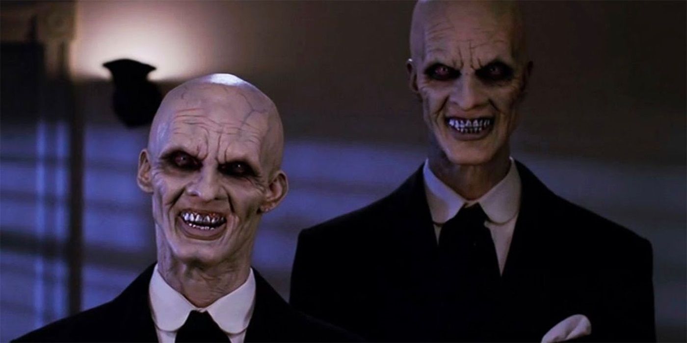 Camden Toy and Doug Jones as The Gentlemen smiling menacingly in Buffy the Vampire Slayer Season 4 