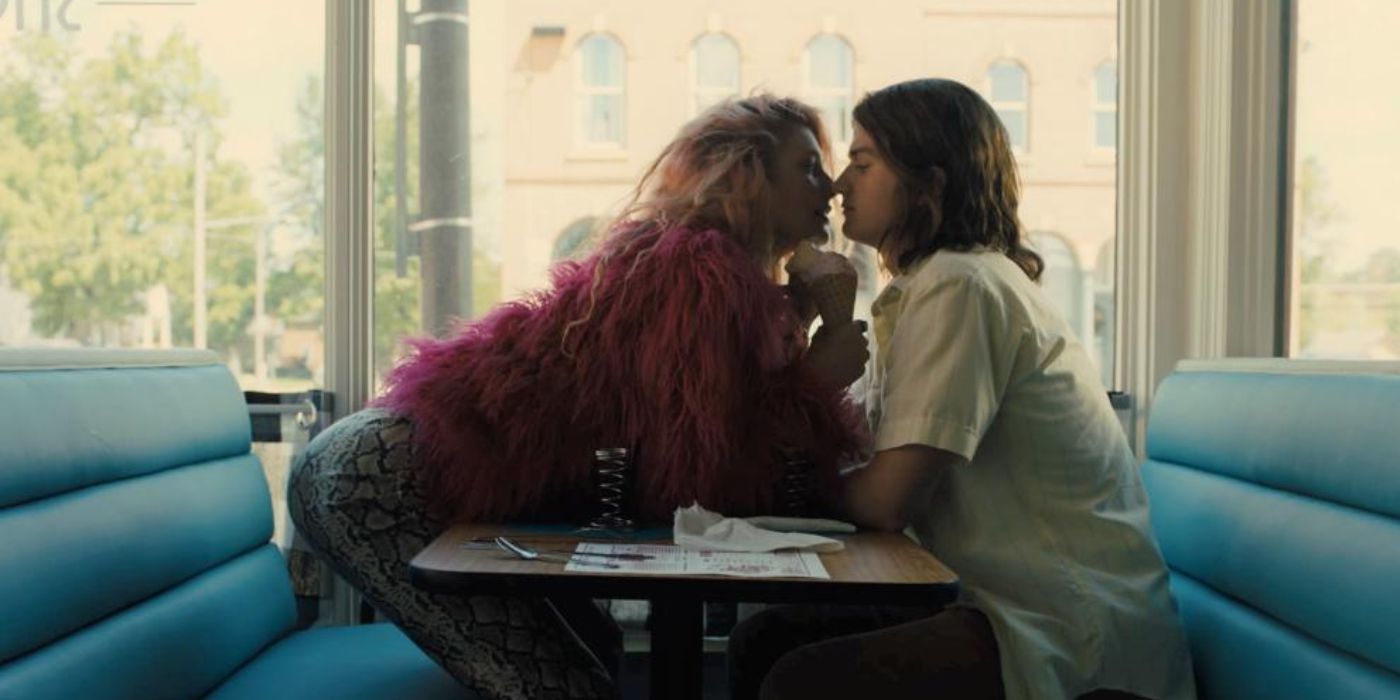 Camila Morrone leaning forward on table to kiss Joe Keery while holding an ice cream in 'Marmalade'.