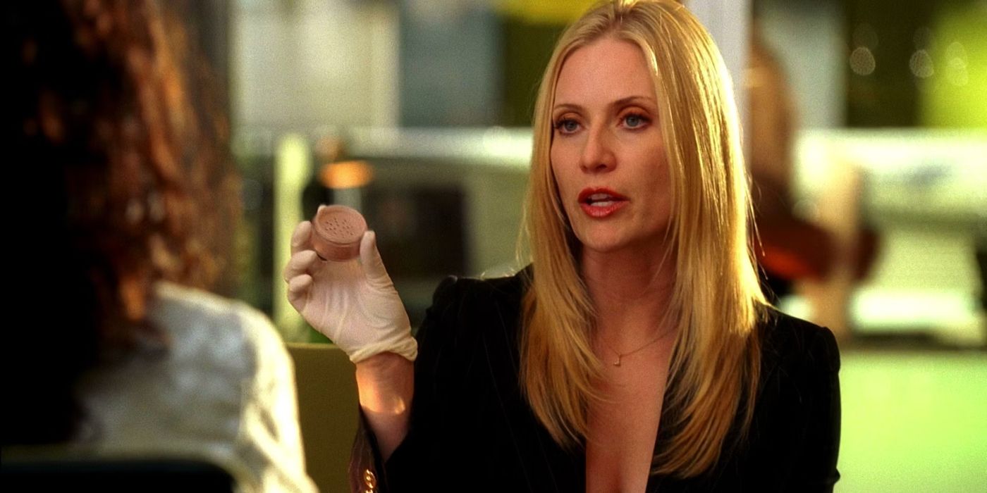 Emily Procter as Calleigh Duquesne holding up evidence in CSI: Miami