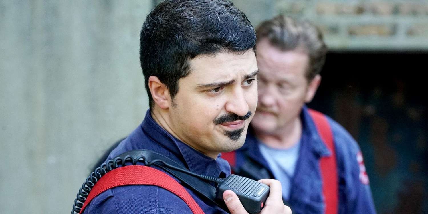 A firefighter talking to a radio 