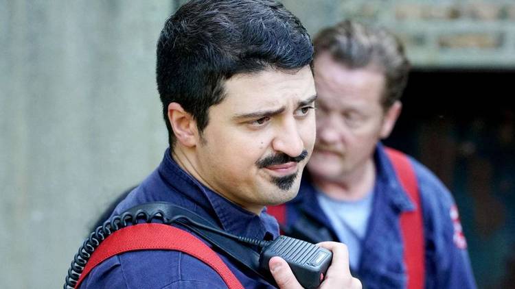 A firefighter talking to a radio