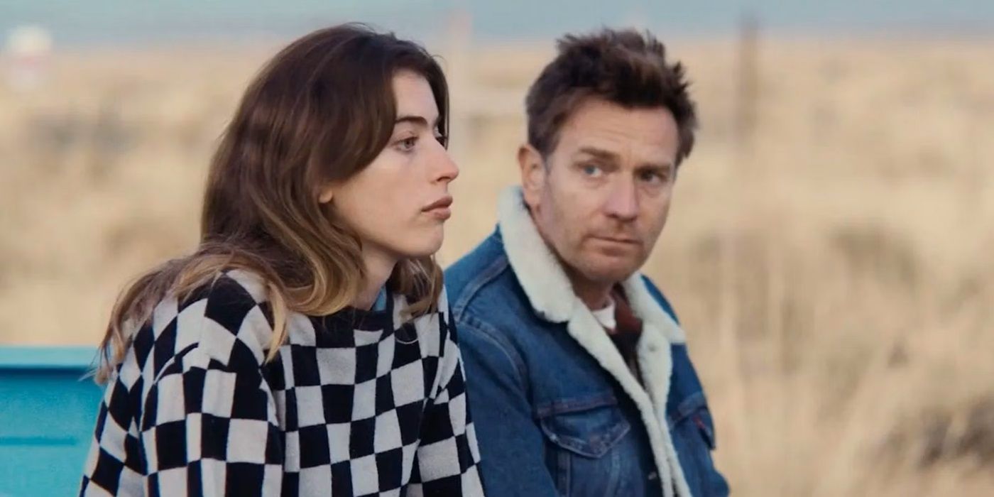 Ewan McGregor looking at Clara McGregor while the duo sits in the back of a truck in Bleeding Love