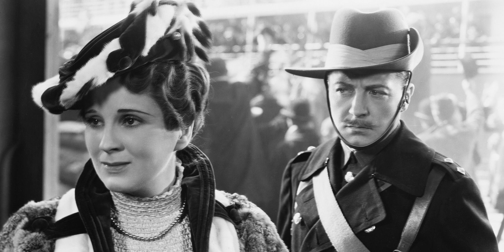 man in old soldier uniform looking at woman in elegant clothes