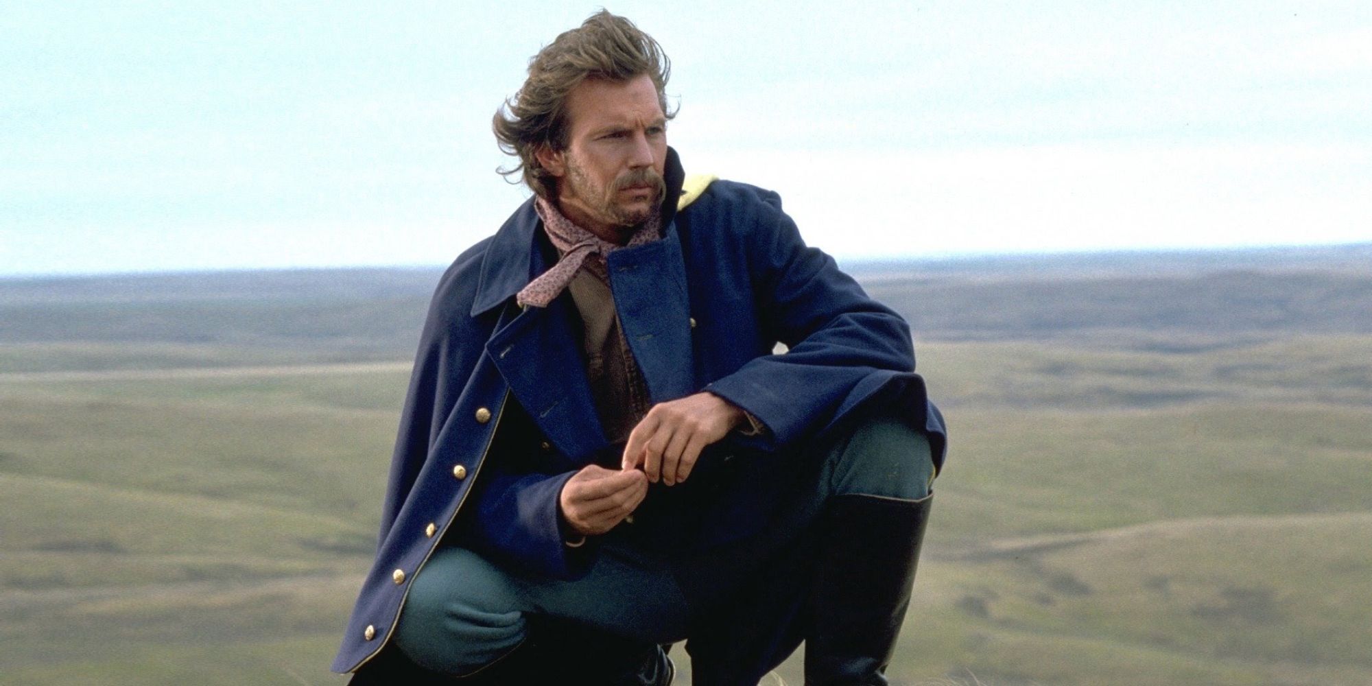 John Dunbar keenling in the desert and looking to the distance in Dances with Wolves