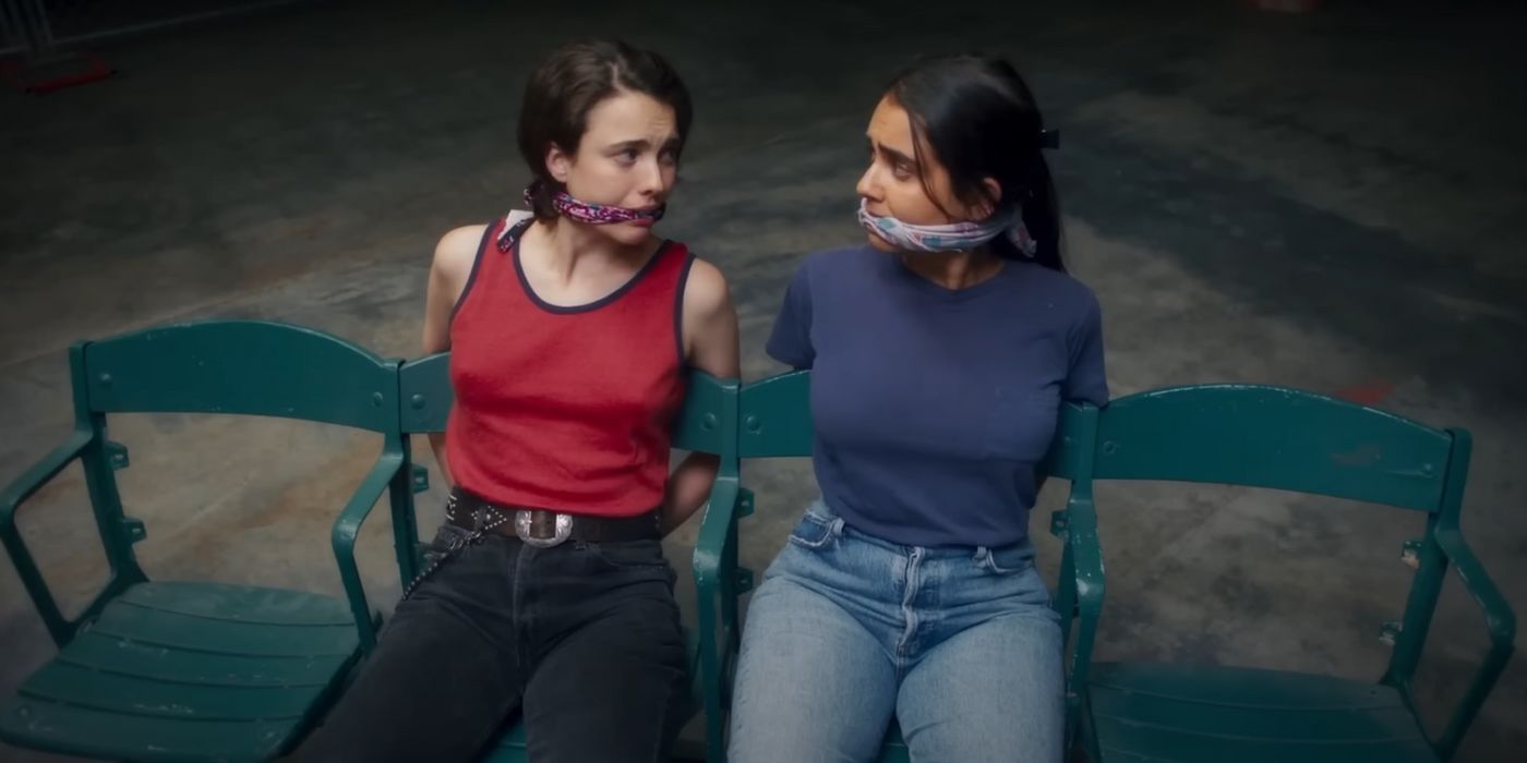 Margaret Qualley and Geraldine Viswanathan, tied and gagged to chairs in Drive-Away Dolls