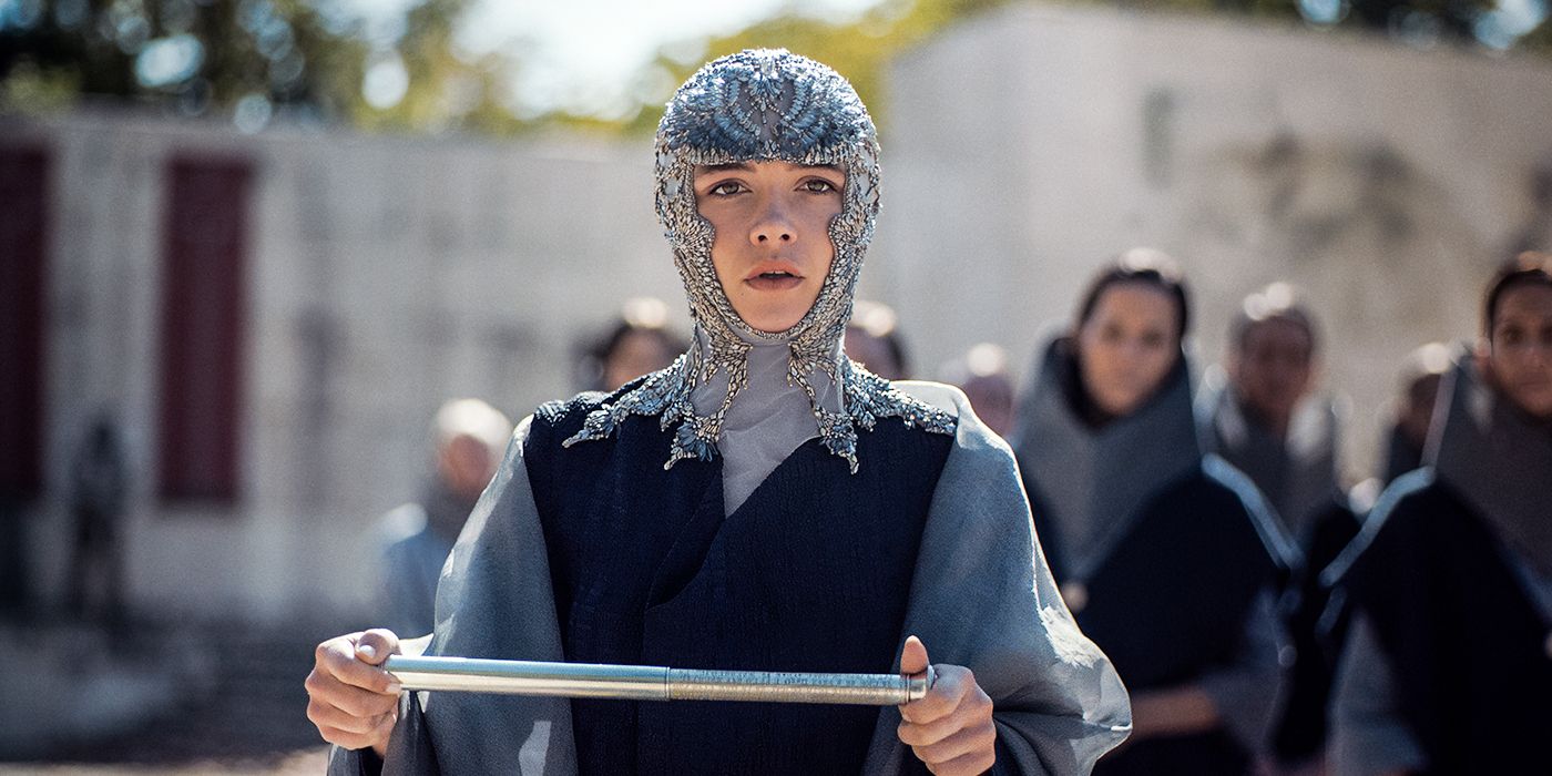 Florence Pugh wearing a chainmail headpiece and reading from a scroll in Dune: Part Two