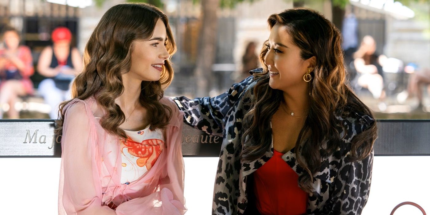 Lily Collins as Emily Cooper and Ashley Park as Mindy Chen sitting on a park bench in Emily in Paris