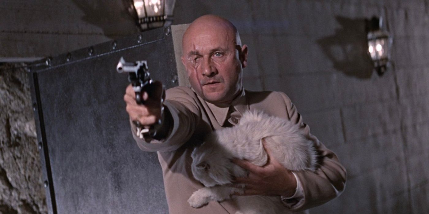 Ernst Stavro Blofeld holds a Persian cat as he aims a revolver in You Only Live Twice.