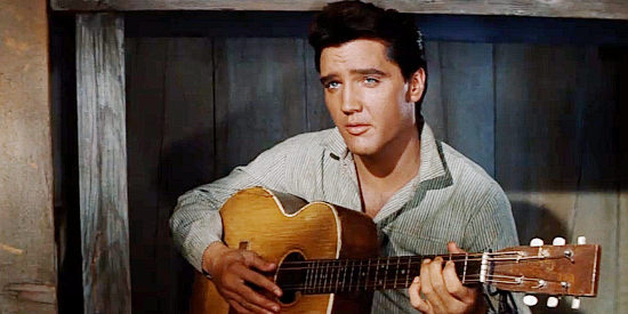 Elvis Presley as Pacer Burton playing guitar in 'Flaming Star'