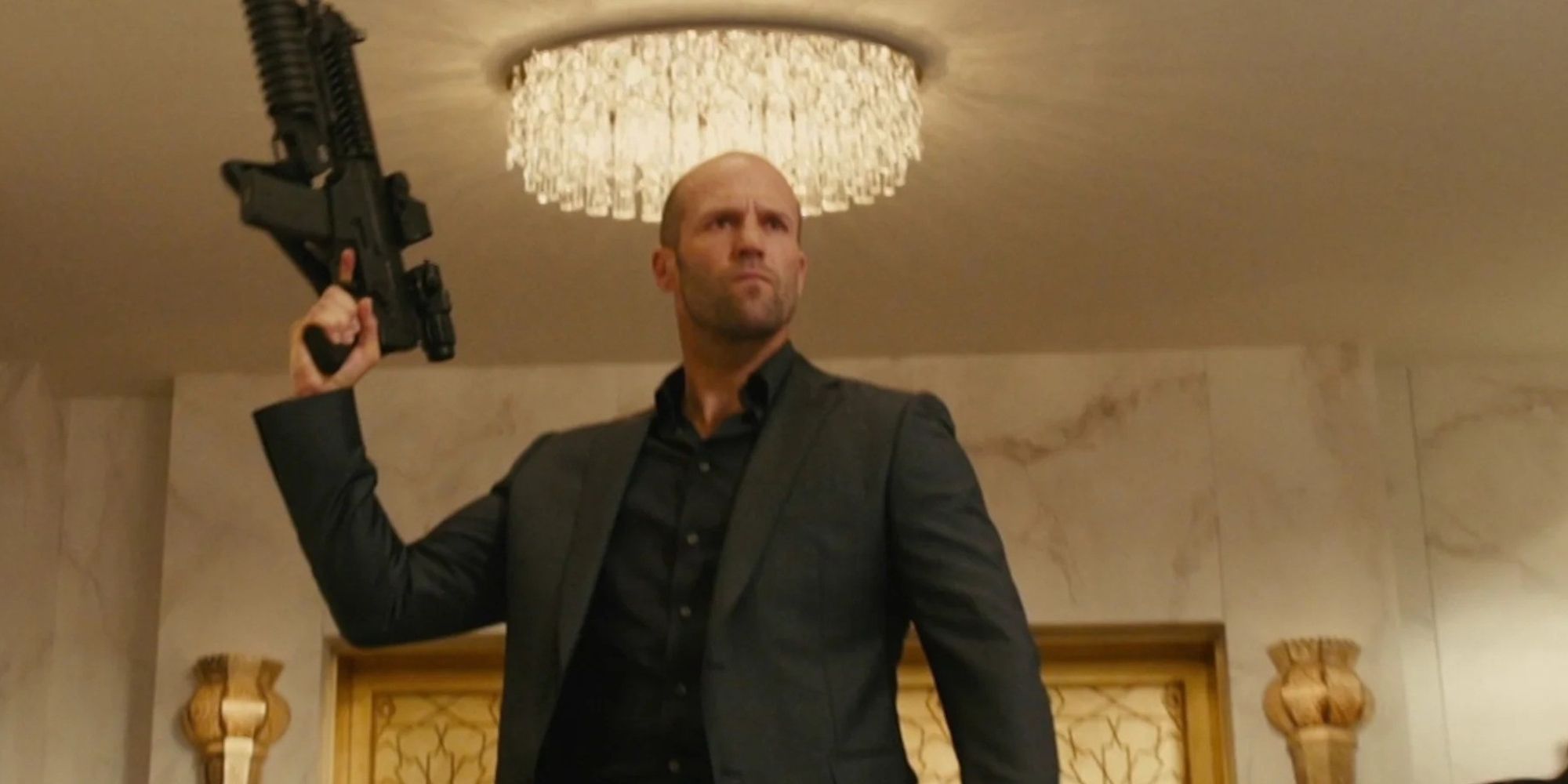 Deckard Shaw holding up a gun in a fancy hotel lobby in Furious 7