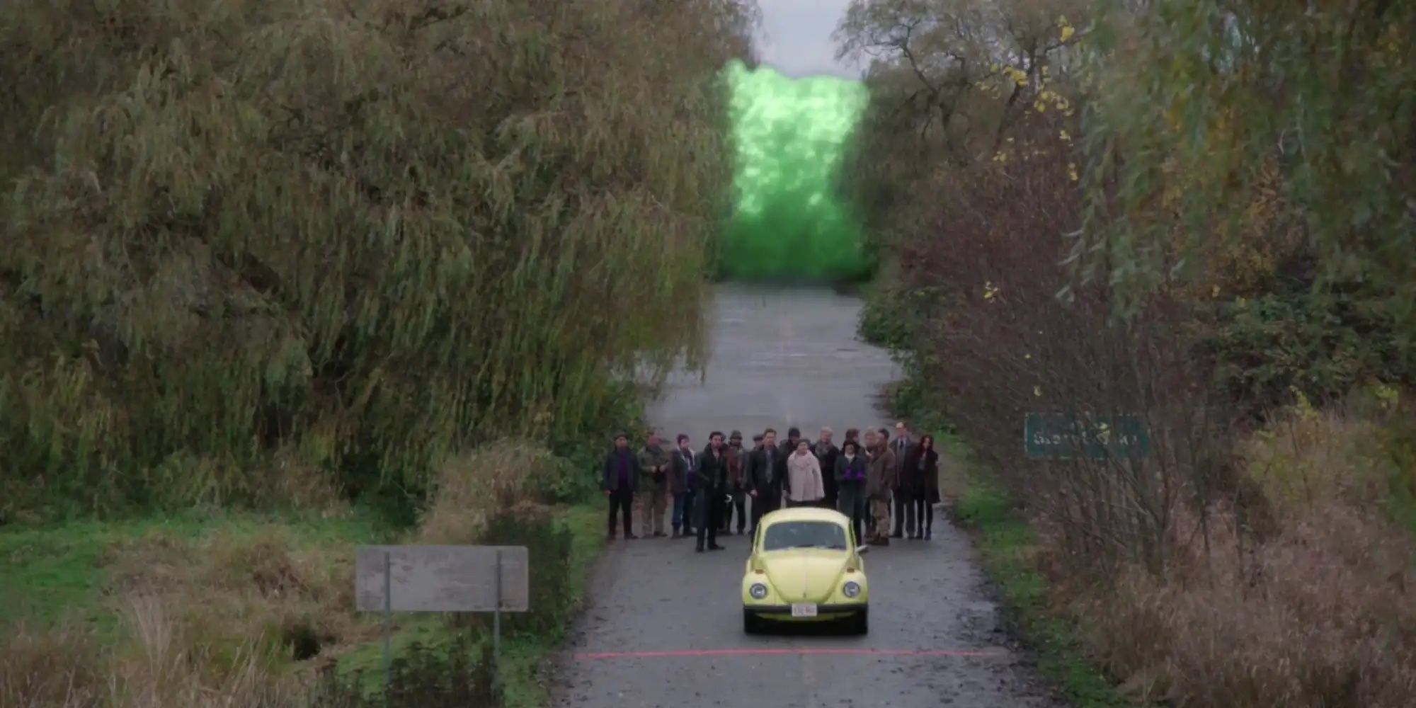 Emma and Henry in a car as they drive away to escape a curse, shown as a bright green light in Once Upon a Time