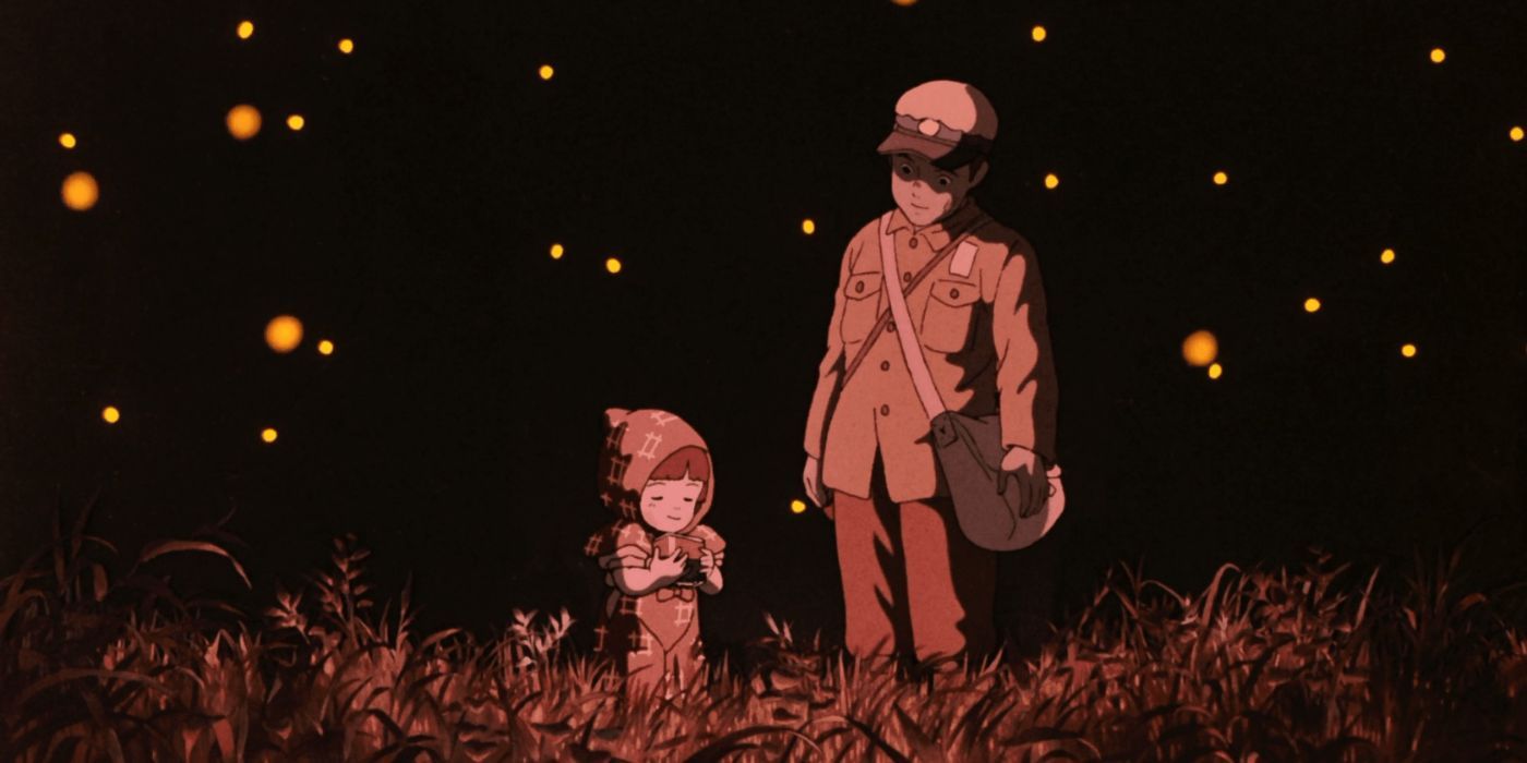 Seita and Setsuko walk in a field of flowers and fireflies in Grave of the Fireflies