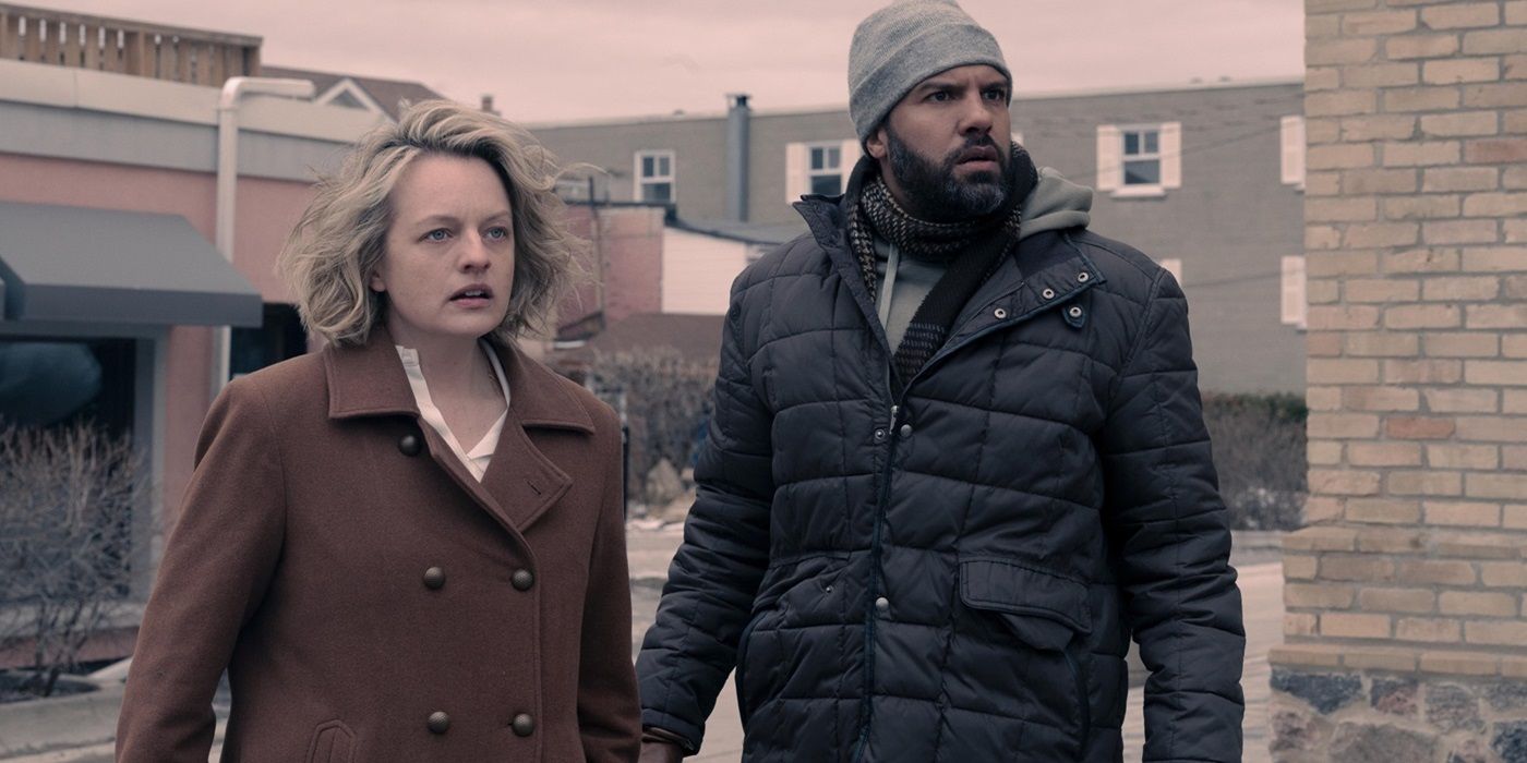 Elizabeth Moss as June and O-T Fagbenle as Luke standing side by side in The Handmaid's Tale Season 5