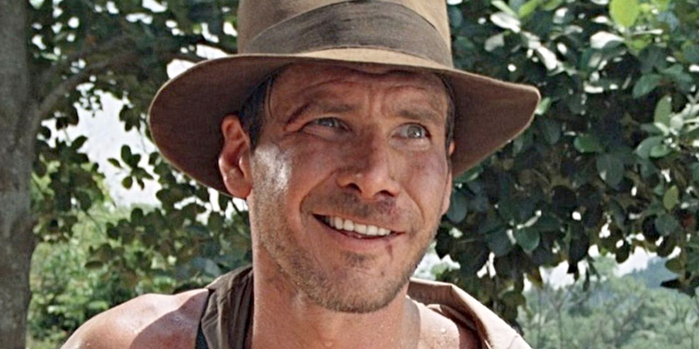 Harrison Ford as Indiana Jones, donning his signature hat and smiling in Indiana Jones and the Temple of Doom