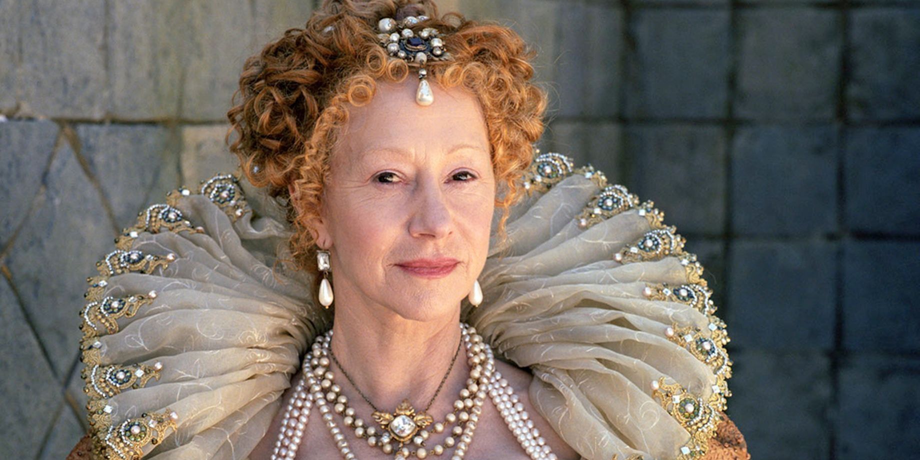 Queen Elizabeth smiling softly while looking intently I in Elizabeth I