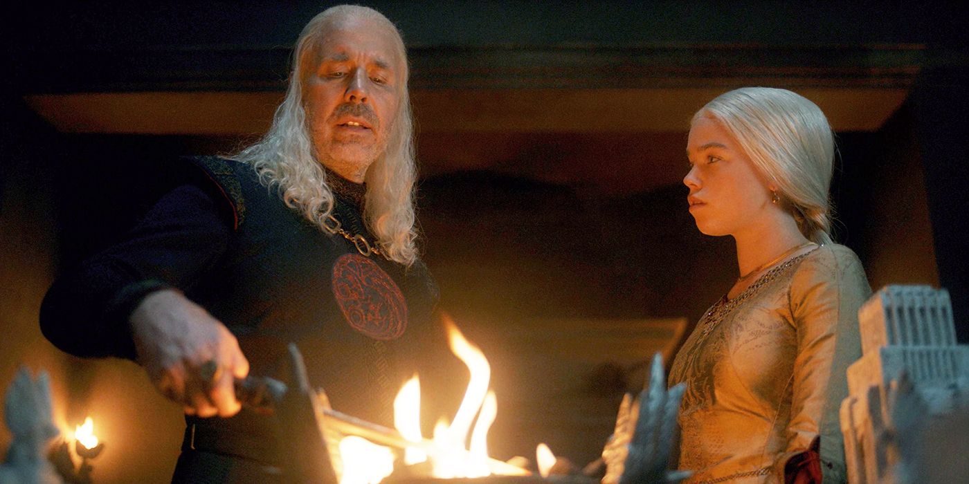 Viserys (Paddy Considine) and Rhaenyra (Milly Alcock) look at the Catspaw Dagger in flame in House of the Dragon