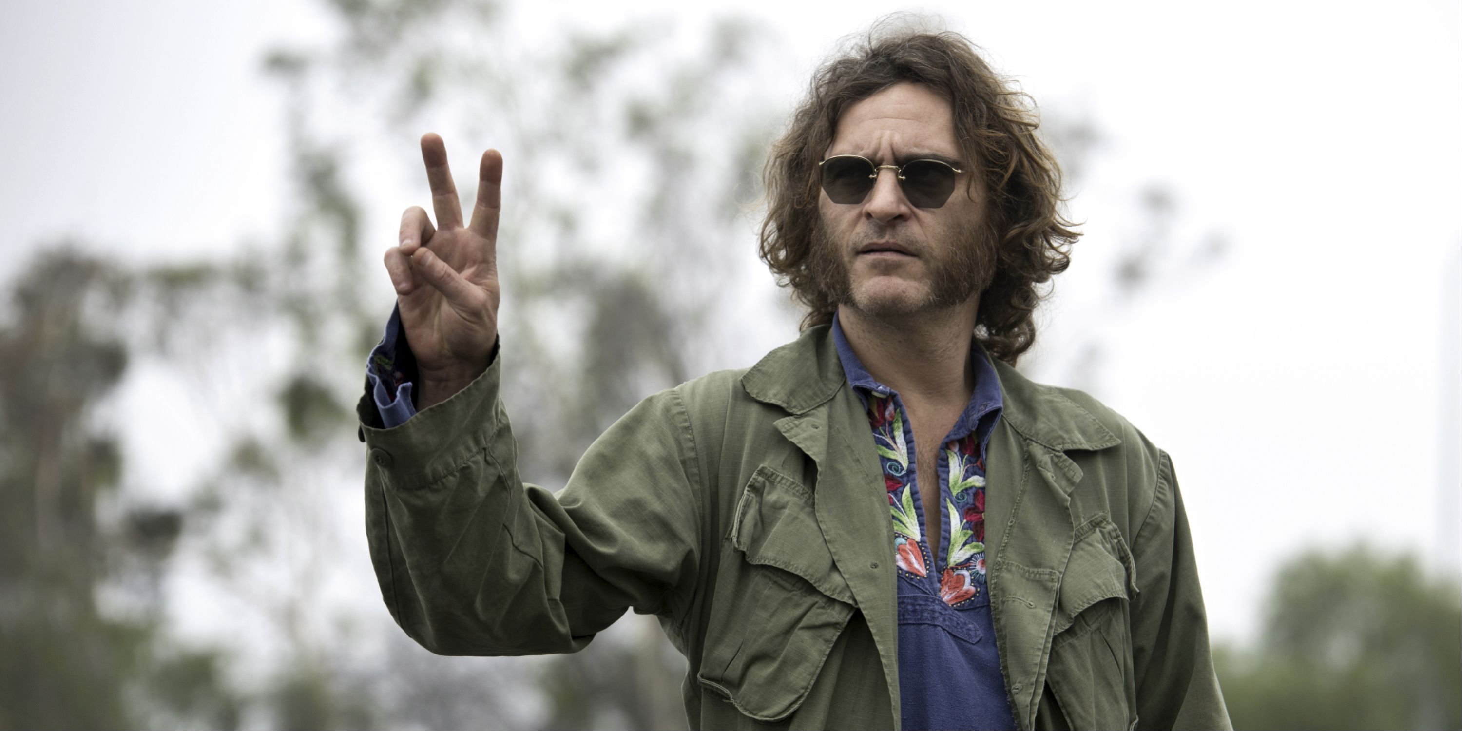 Joaquin Phoenix as Doc Portello giving a peace sign in Inherent Vice