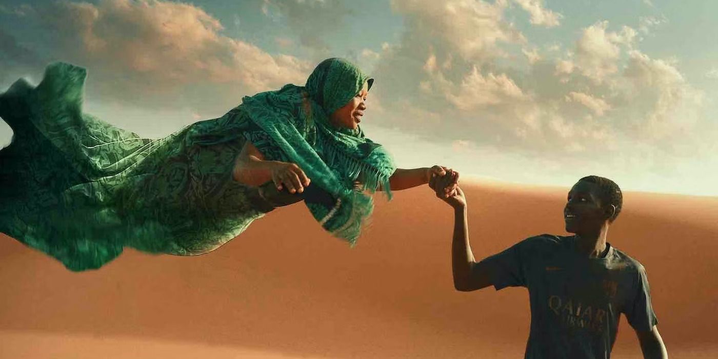 Seydou clings the hands of a floating woman in the Sahara Desert in the daytime in Io Capitano.