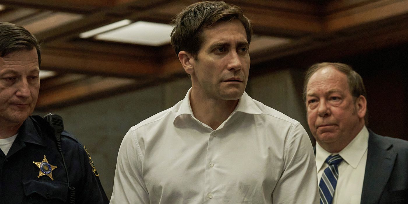 Jake Gyllenhaal disheveled and flanked by a cop and lawyer in court in Presumed Innocent