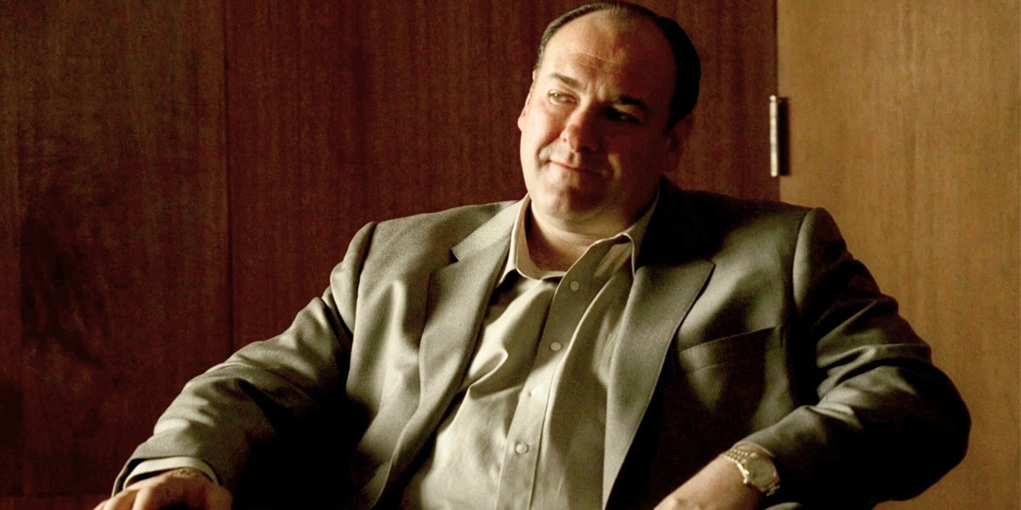 James Gandolfini sitting in a chair looking off to the side in The Sopranos-1