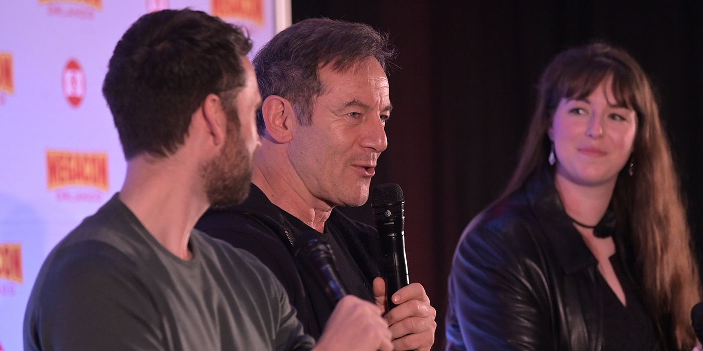 Jason Isaacs speaking on stage at MegaCon flanked by Matthew Lewis and Maggie Lovitt