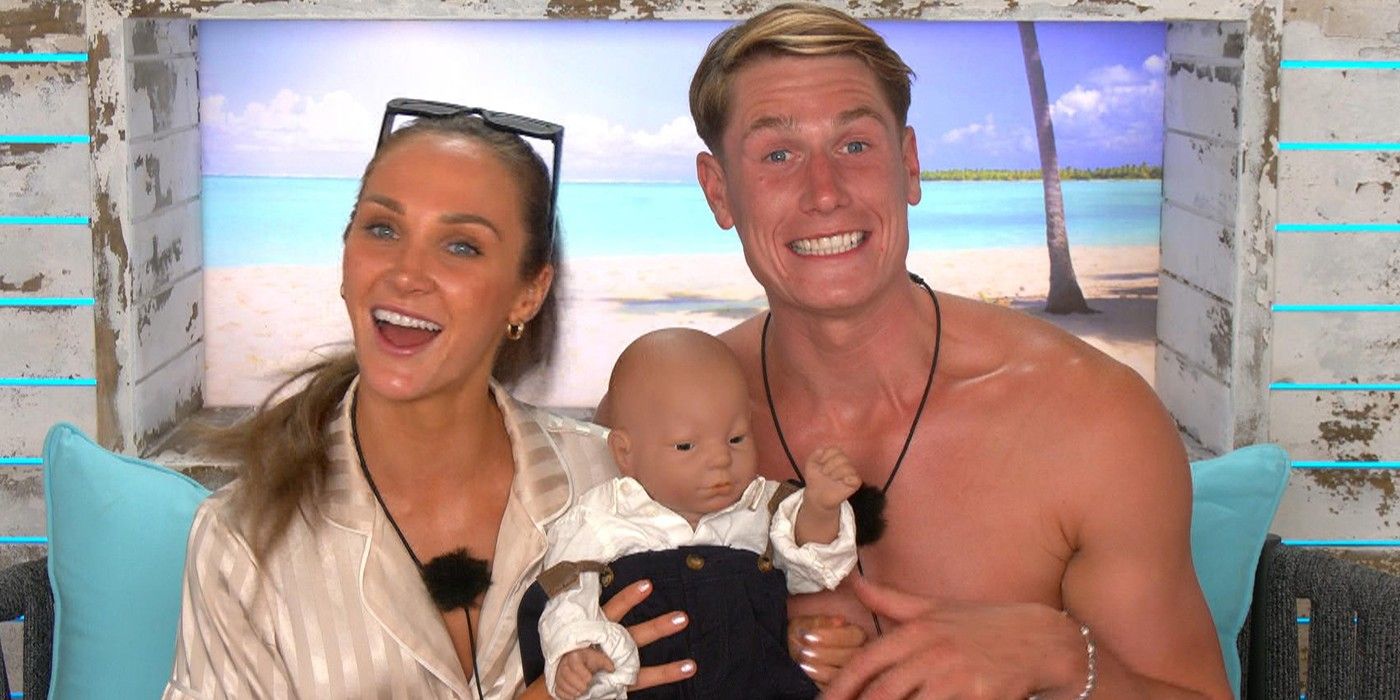 Jessie & Will smile in the confessional while holding a fake baby, in Love Island UK