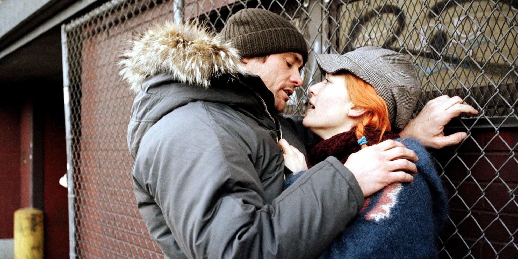 Jim Carrey and Kate Winslet embracing against a fence in Eternal Sunshine of the Spotless Mind (2004)