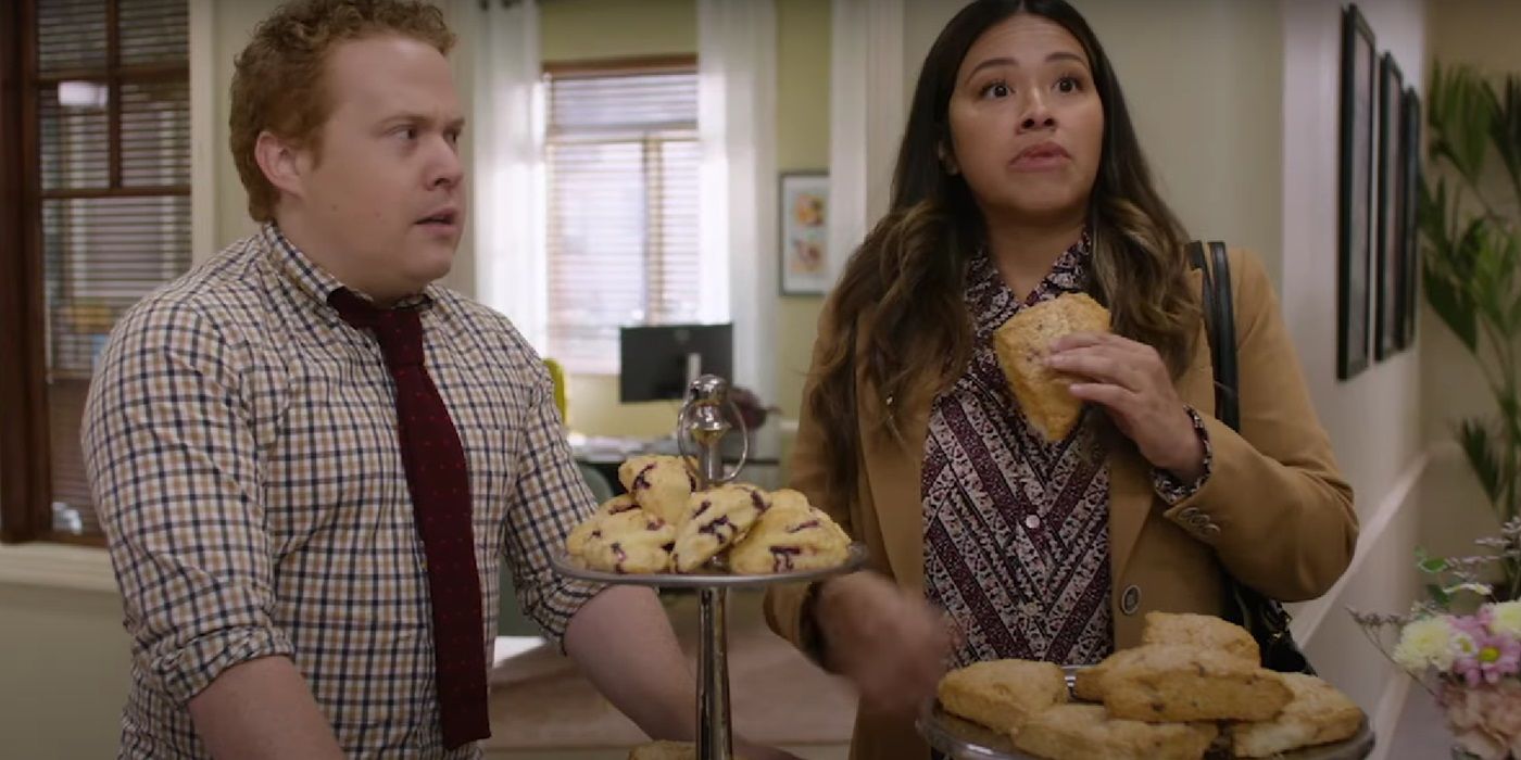 Jimmy Bellinger and Gina Rodriguez look shocked, eating pastries in Not Dead Yet Season 2.