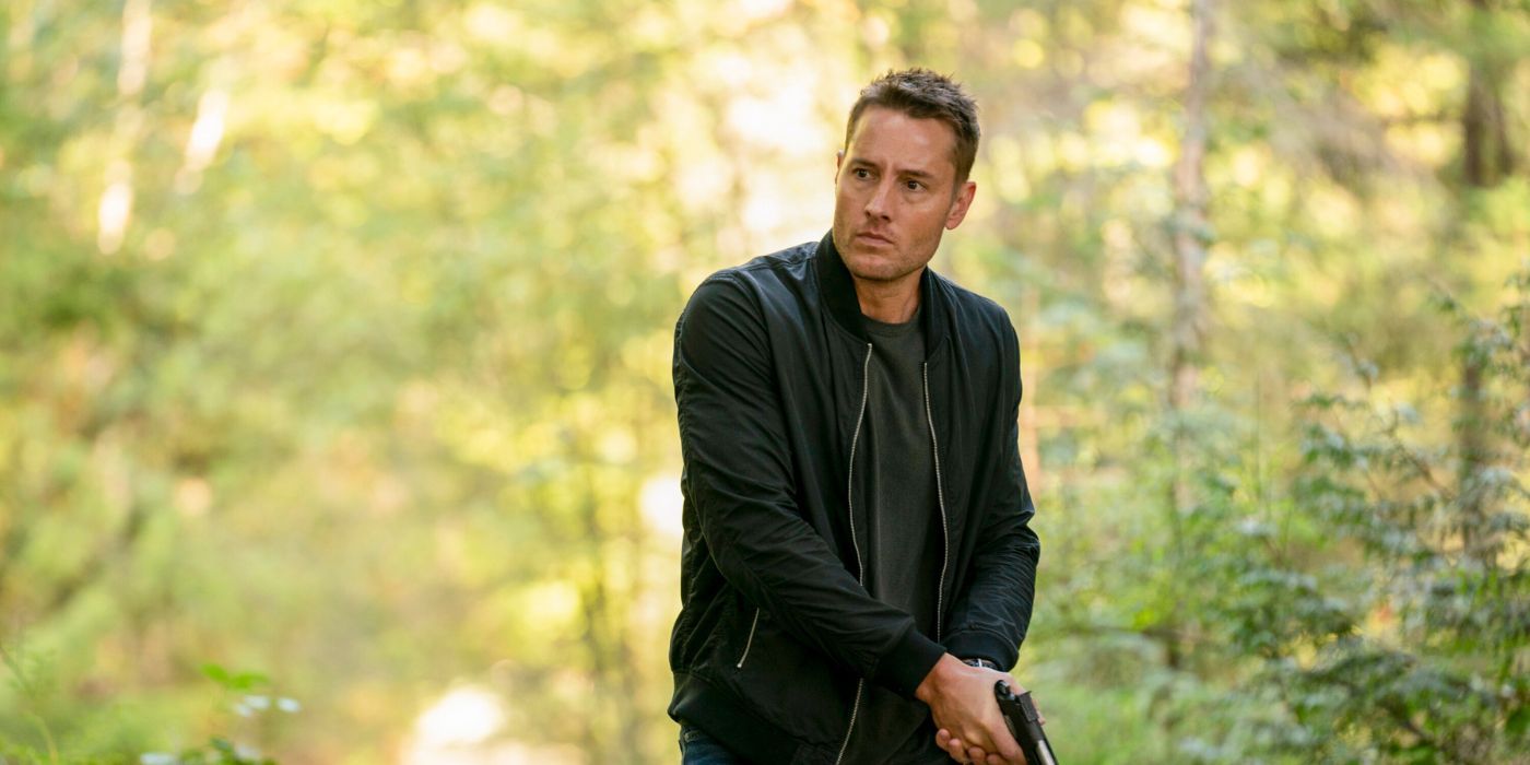 Justin Hartley as Colter Shaw, clutching his pistol while walking through the woods, in Tracker