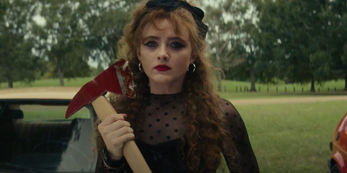 Kathryn Newton dressed in black and holding an axe in Lisa Frankenstein