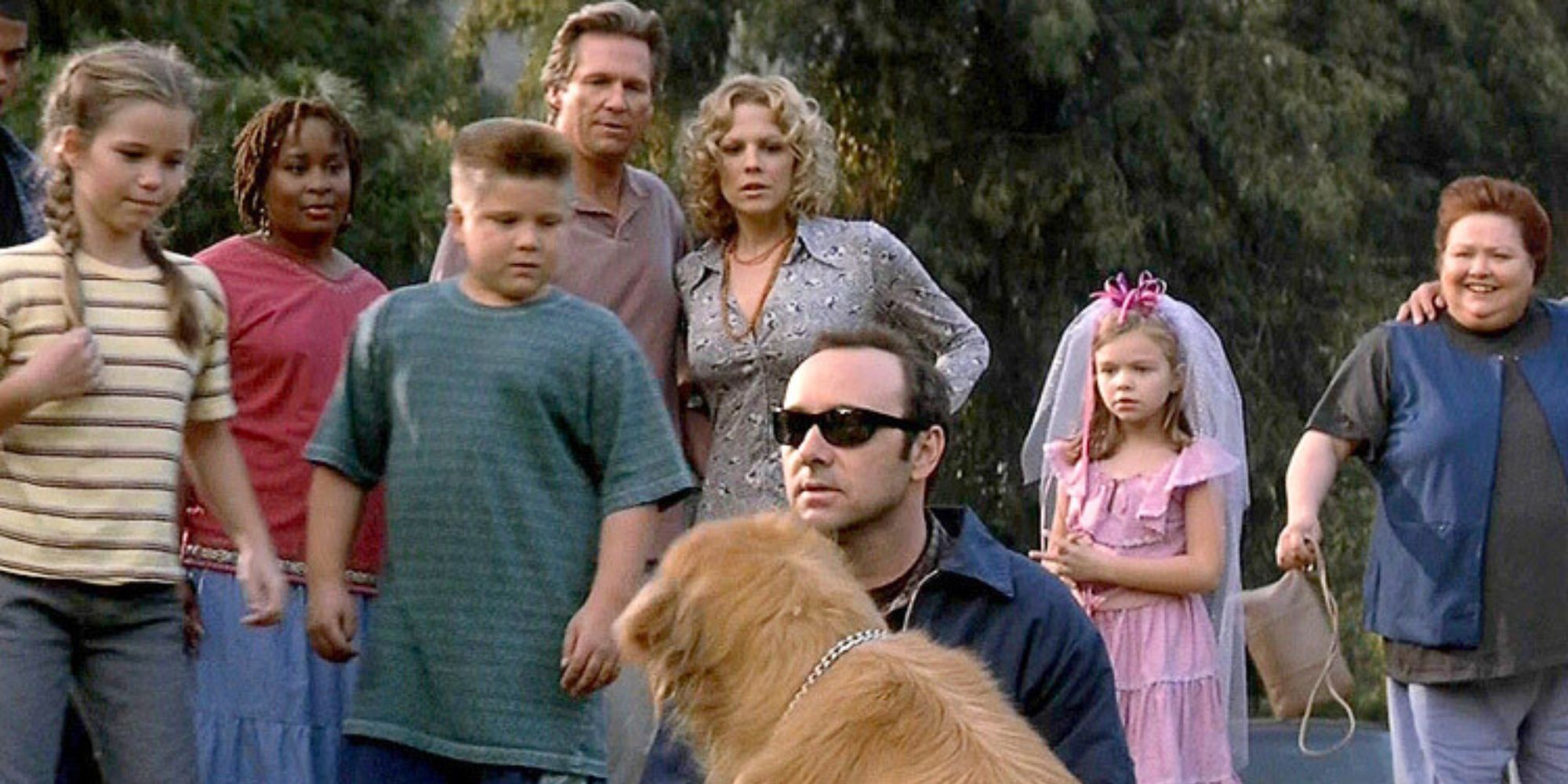 Kevin Spacey sitting in front of a dog on the ground surrounded by Jeff Bridges and others in K-Pax (2001)