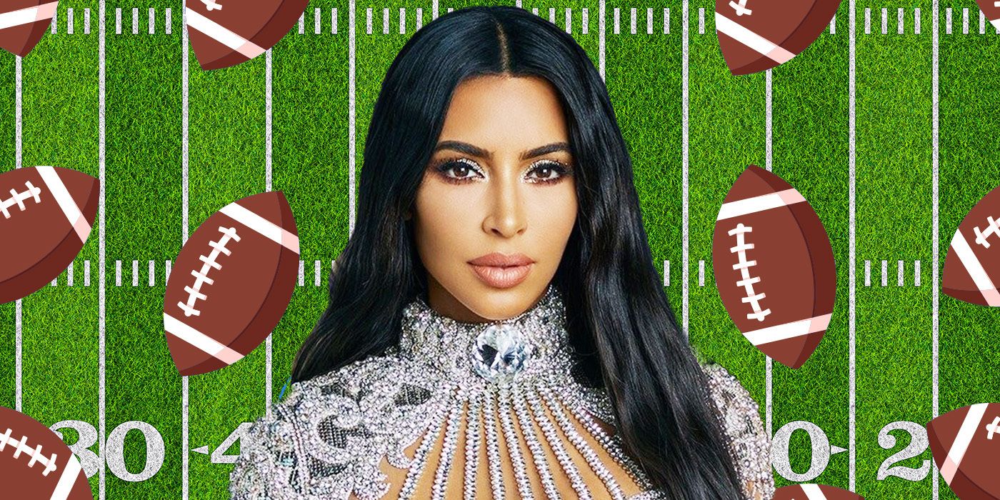 Kim Kardashian poses with footballs surrounding her