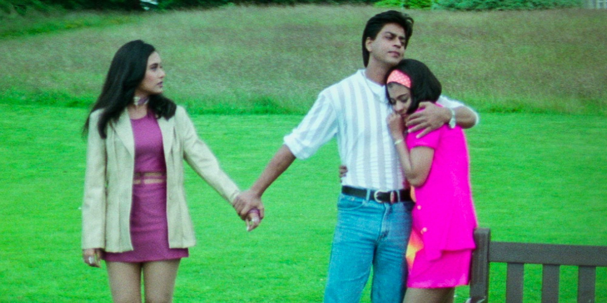 Shah Rukh Khan hugging Kajol but holding on to Rani Mukerji in a field in Kuch Kuch Hota Hai