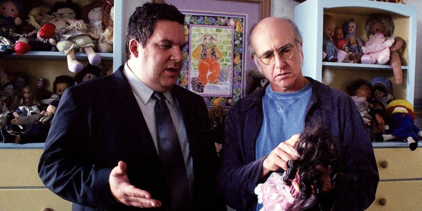 Larry David and Jeff Garlin staring at a doll in Curb Your Enthusiasm
