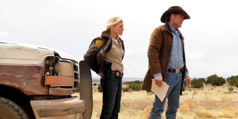 Katee Sackhoff as Victoria 'Vic' Moretti and Robert Taylor as Walt Longmire, standing outside by a truck and looking dismayed in Longmire