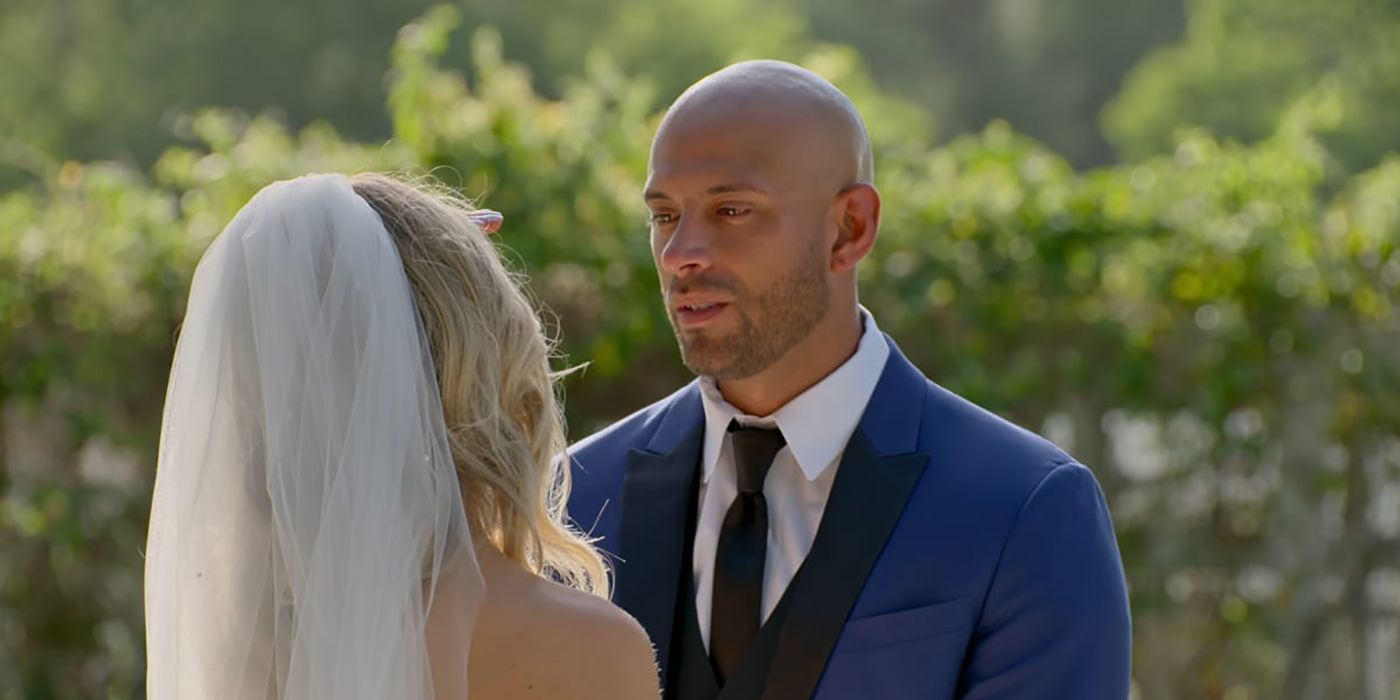 Izzy looking at Stacy in a wedding dress in a scene from Love is Blind.