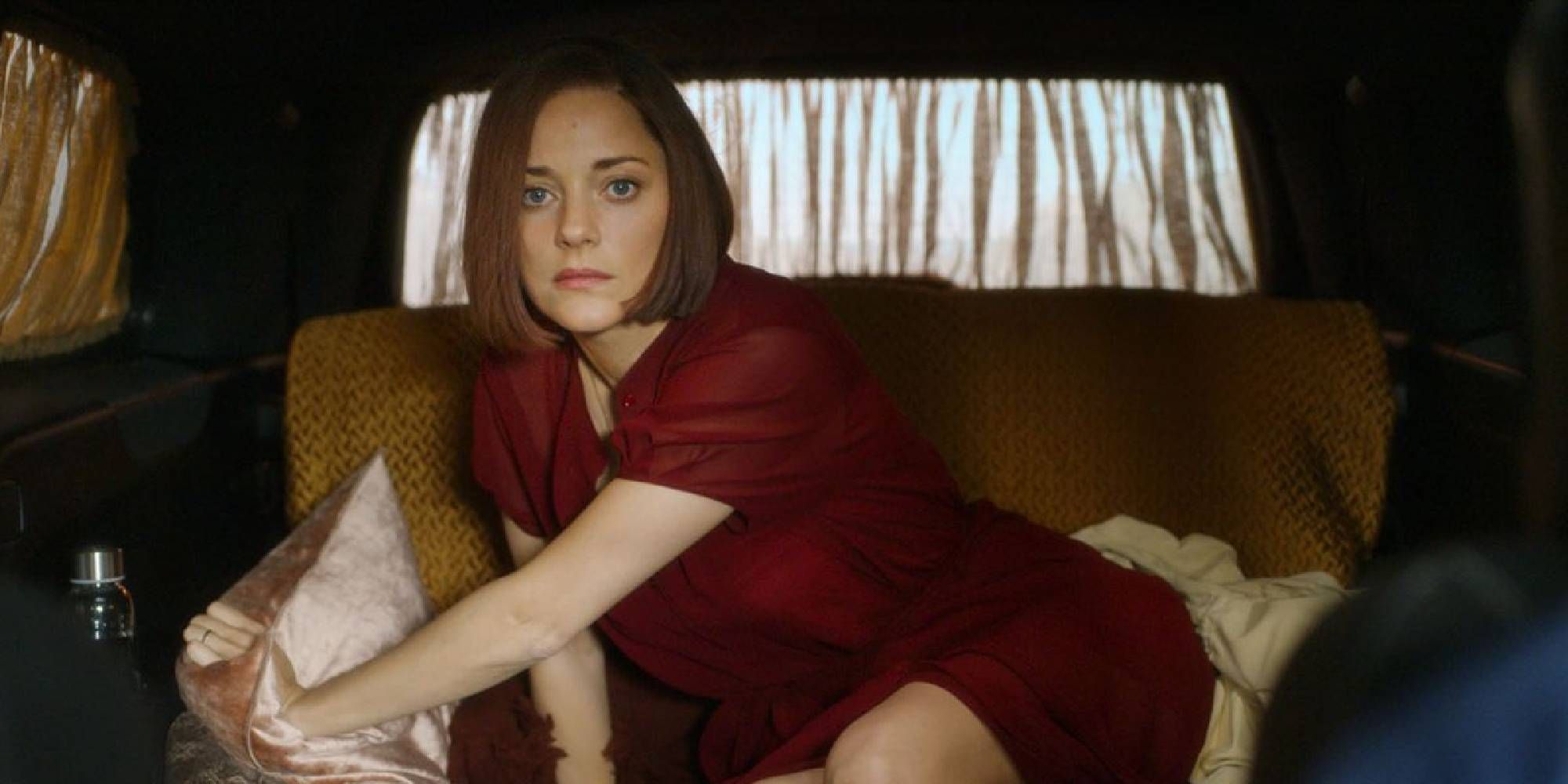 Marion Cotillard in Annette inside a car.