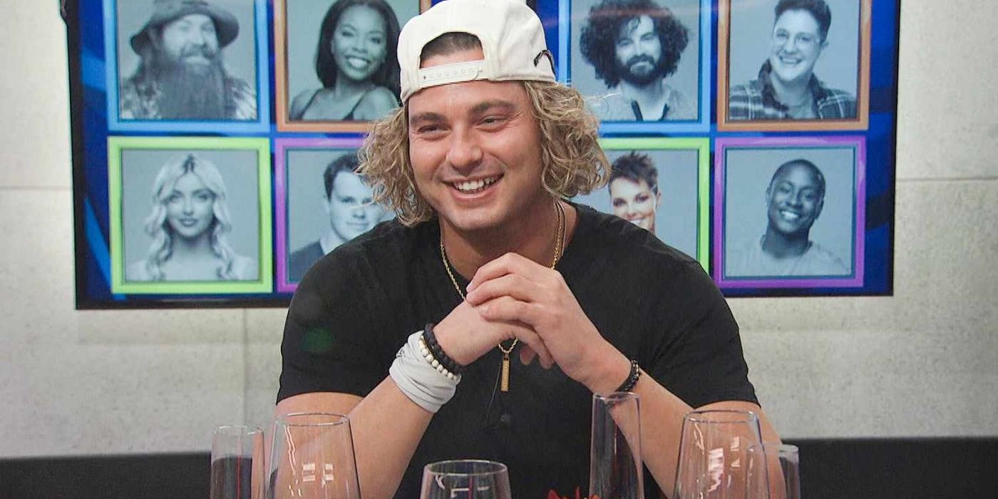 Matt Klotz wears a backwards baseball cap and bracelets and sits at a table with a smile on his face on Big Brother.