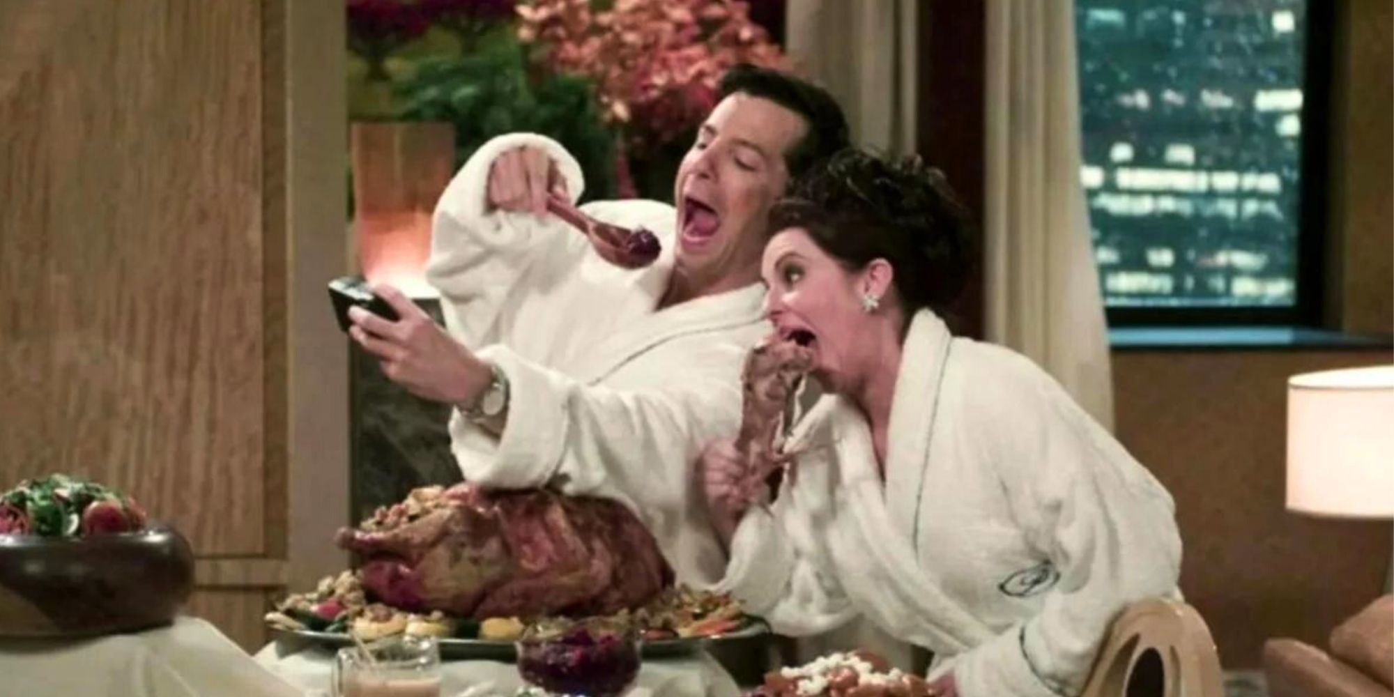 Megan Mullally and Sean Hayes taking a picture of themselves eating turkey in Will &amp; Grace