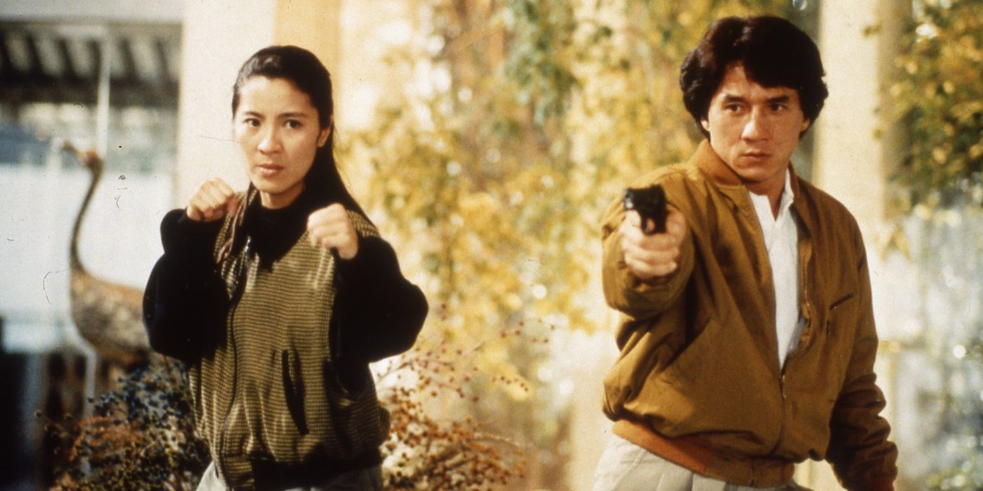 Michelle Yeoh and Jackie Chan standing side by side in battle poses in Police Story 3: Supercop