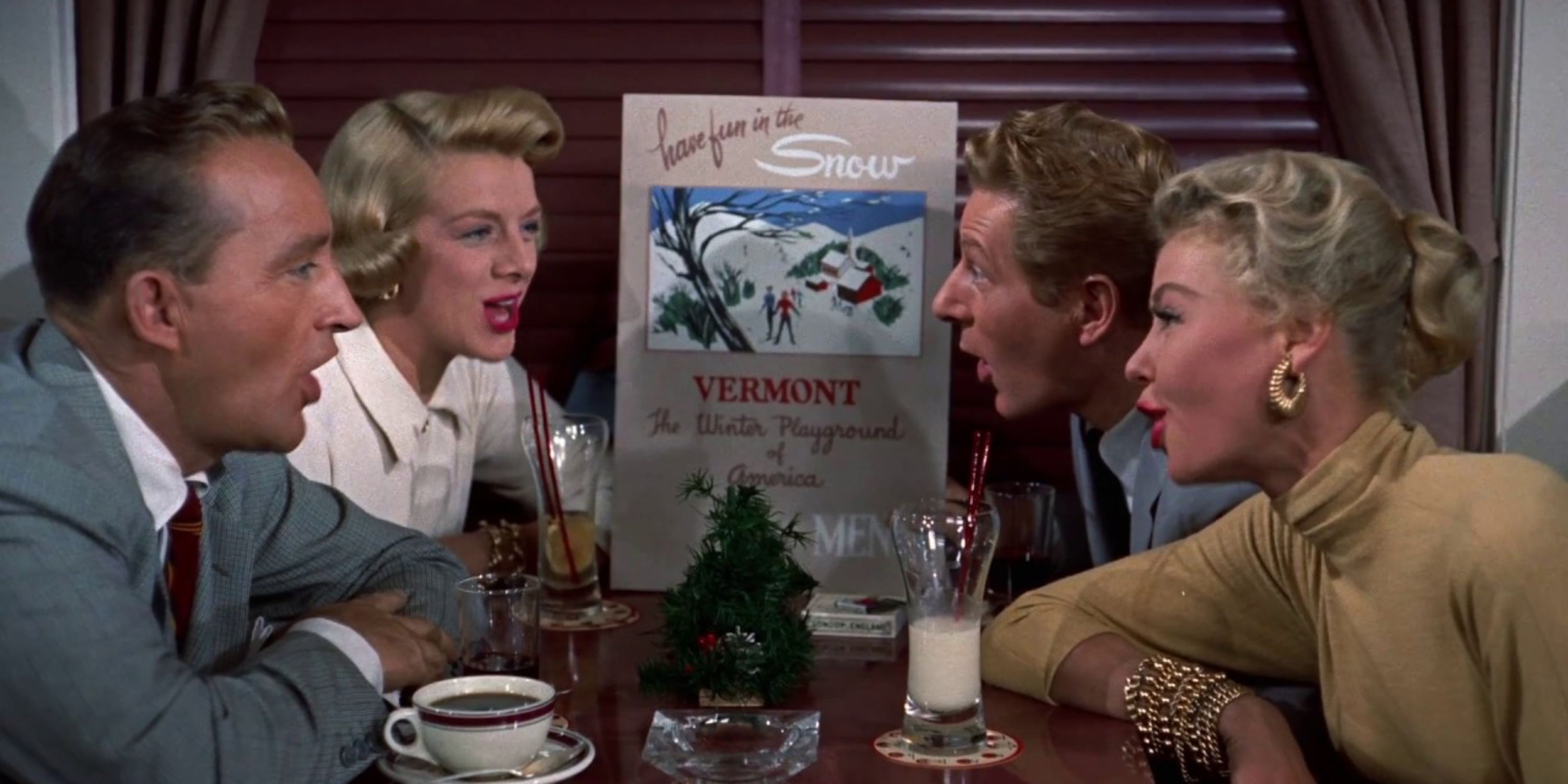 Four characters singing at a table together in White Christmas