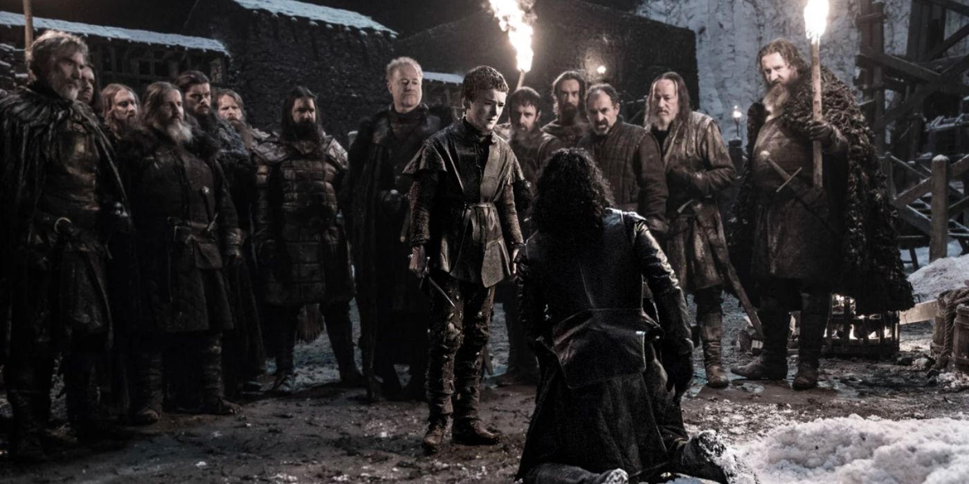 Mutineers of the Night's Watch crowd around as a young boy stabs Jon Snow (Kit Harrington) in the chest.